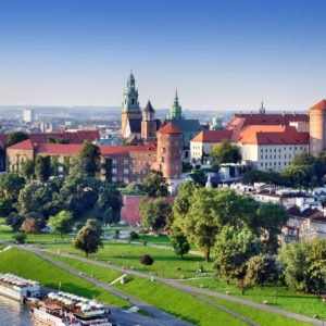 Historic royal Wawel castle in Cracow, Poland with park and Vistula river. Aerial view at sunset.